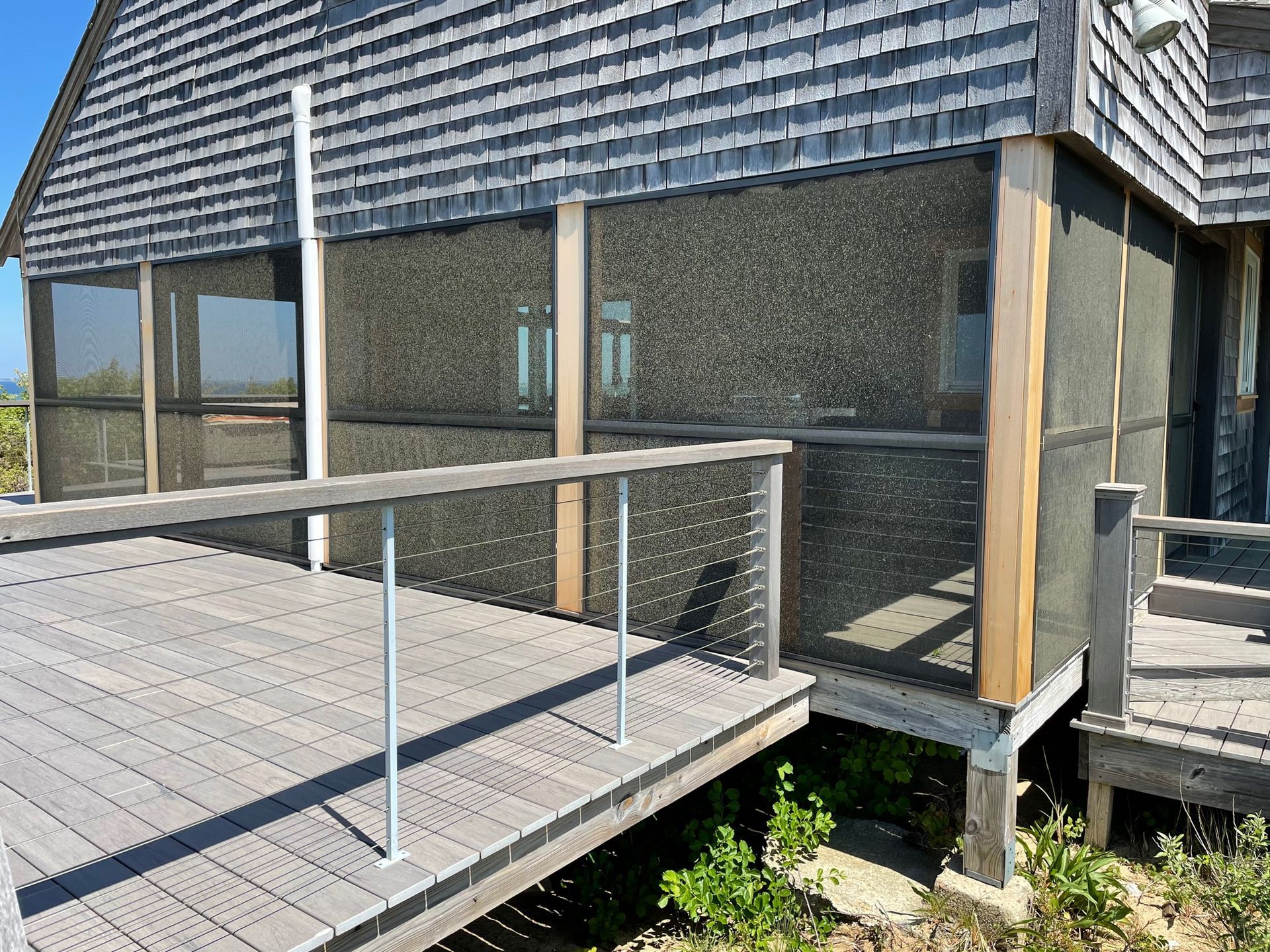 a screened in porch on the side of a house