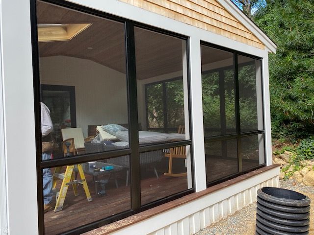 a screened in porch with a lot of windows