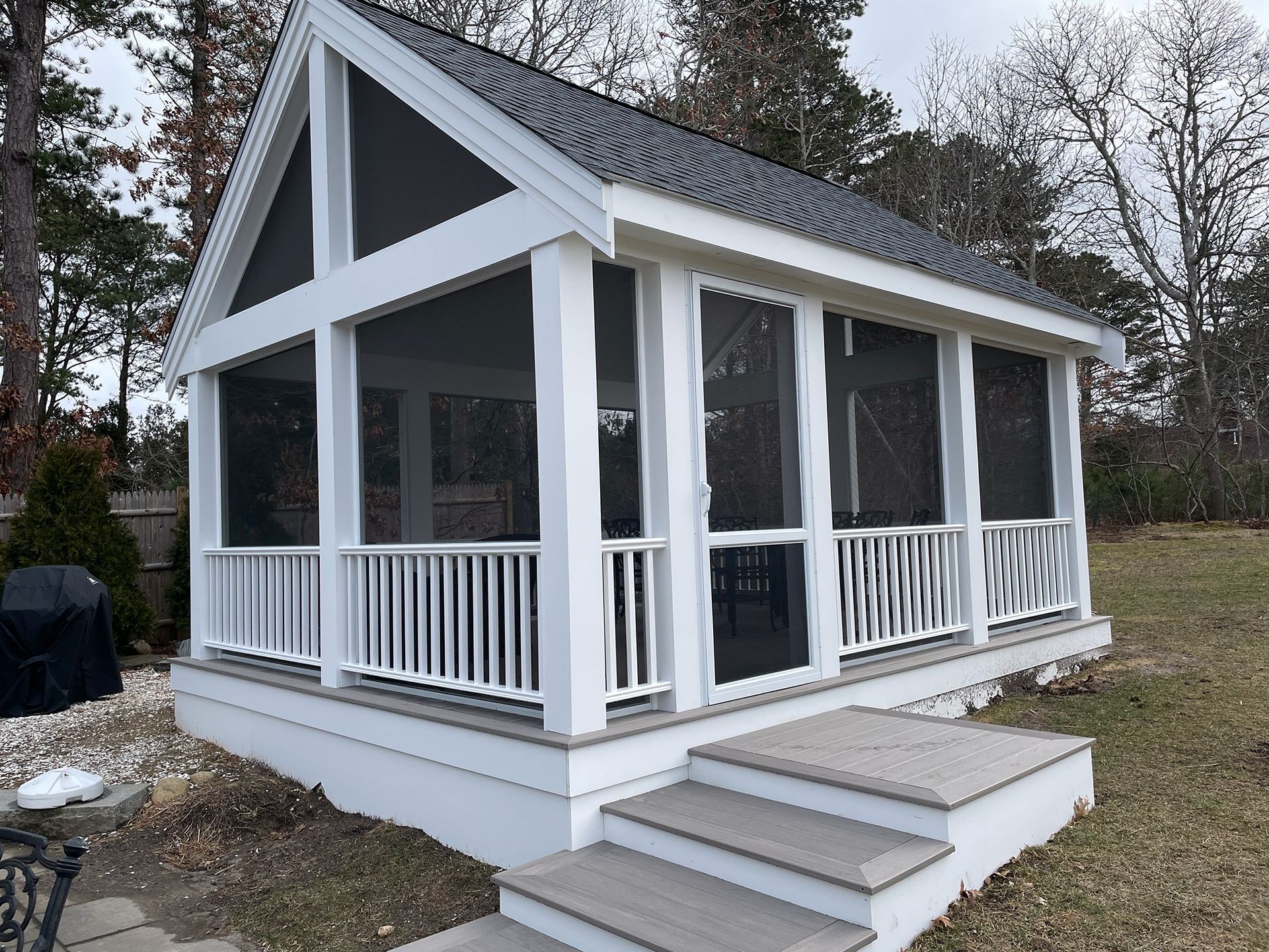 a screened in porch with stairs leading up to it