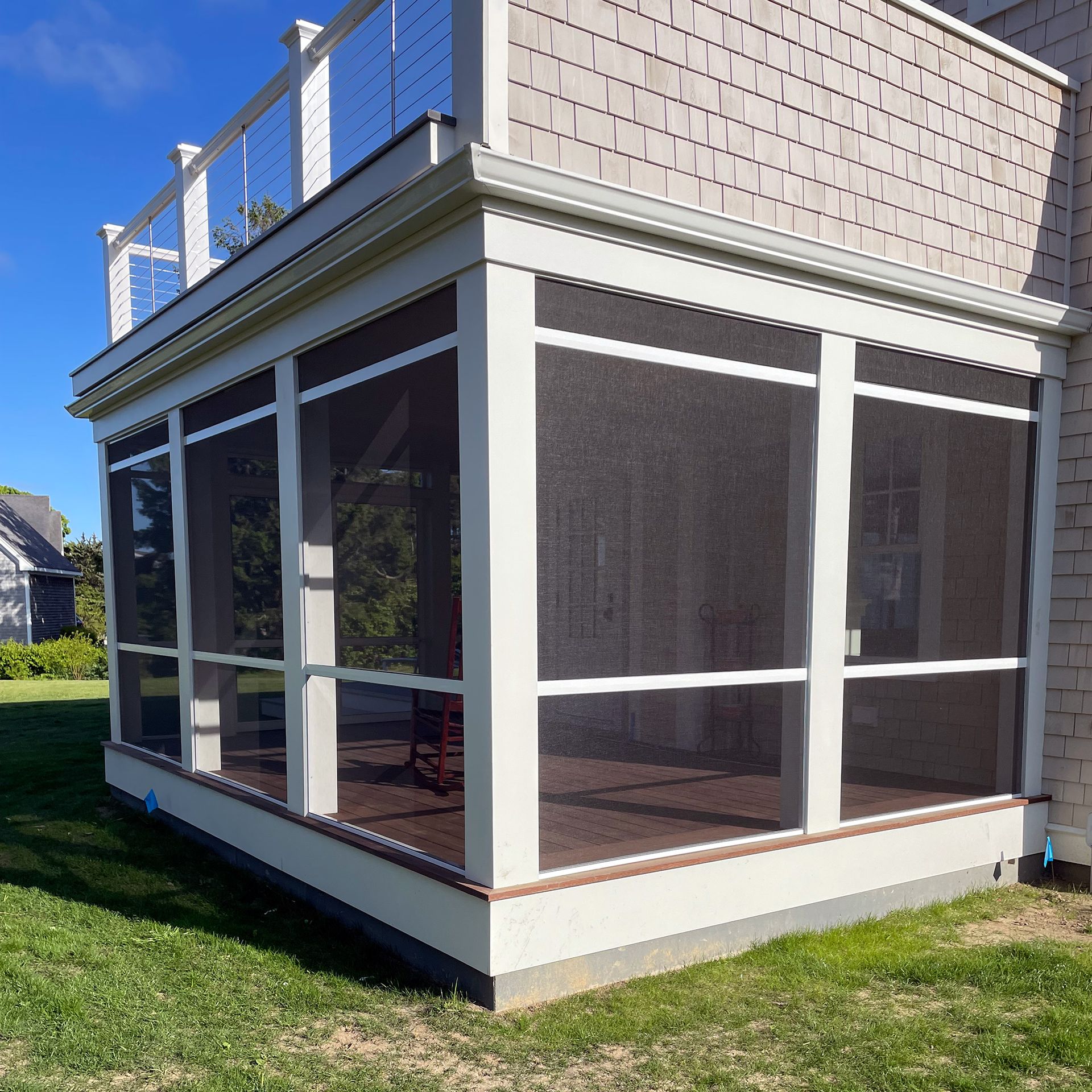 a screened in porch on the side of a house
