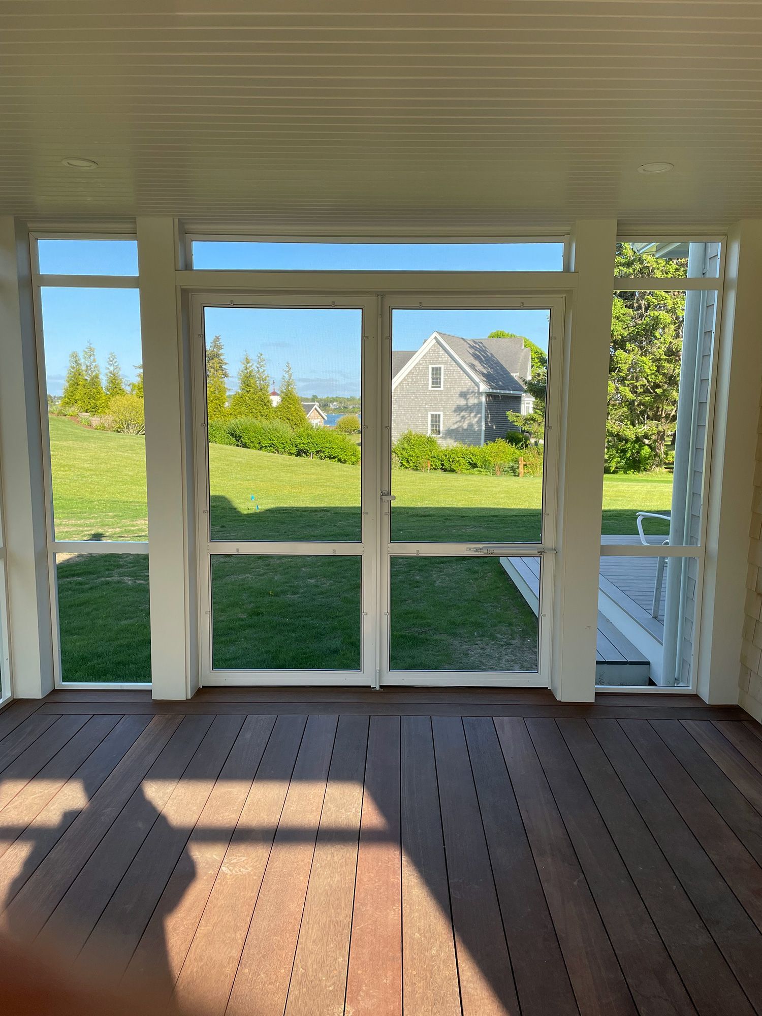 a room with a lot of windows and a wooden floor