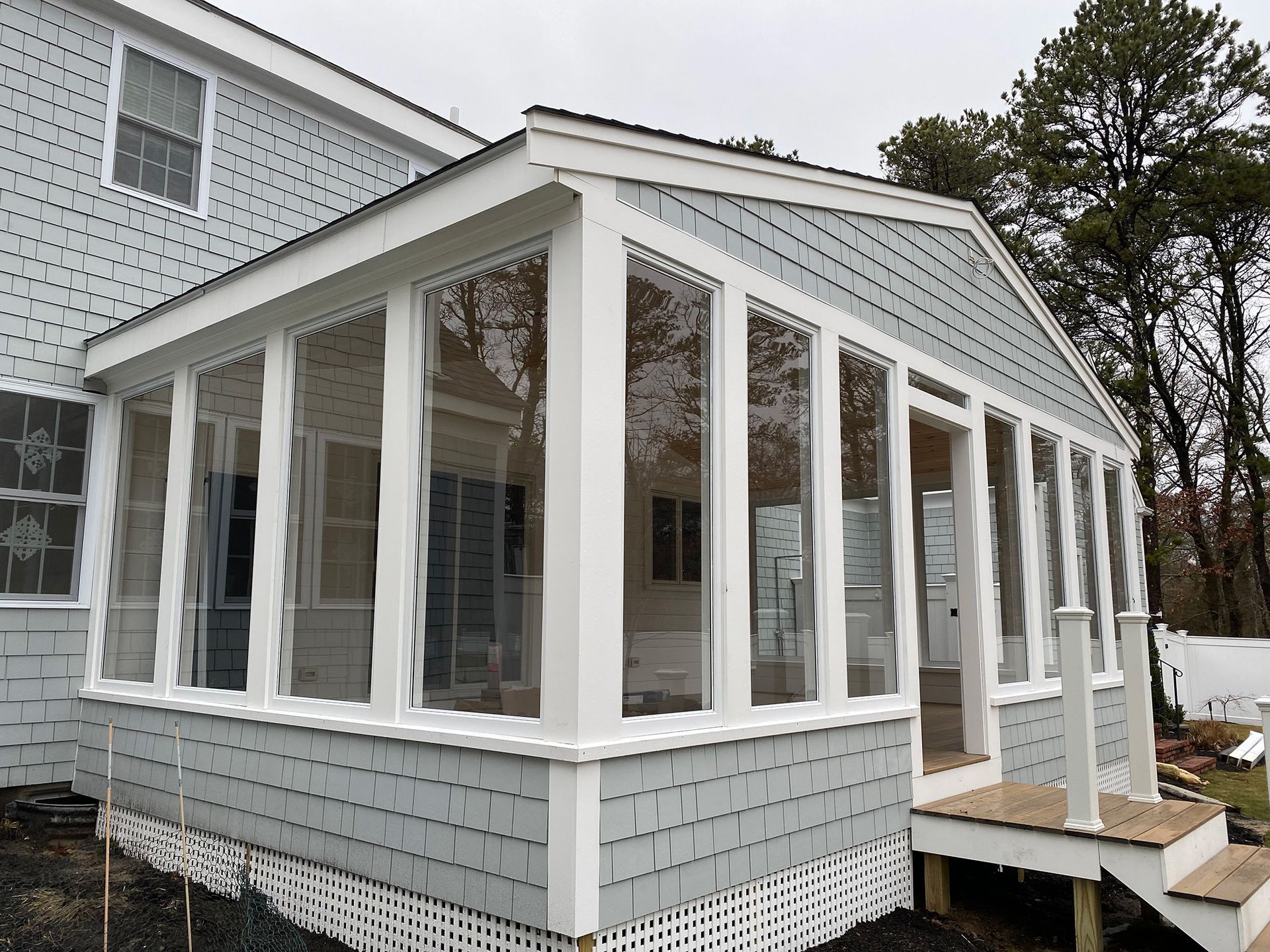 a screened in porch on the side of a house