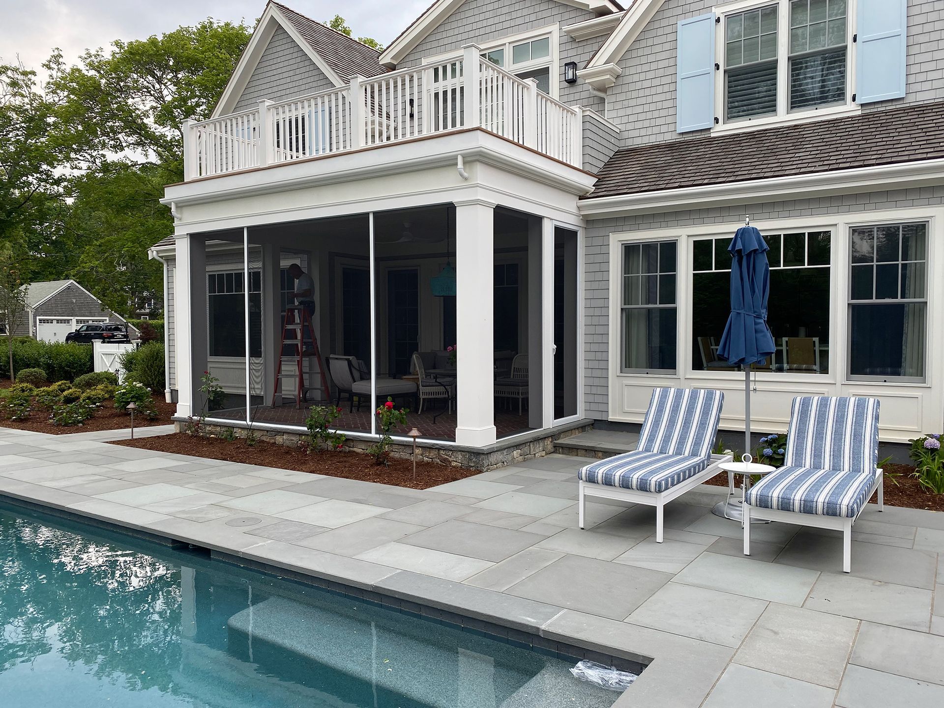 a large house with a screened in porch and a swimming pool