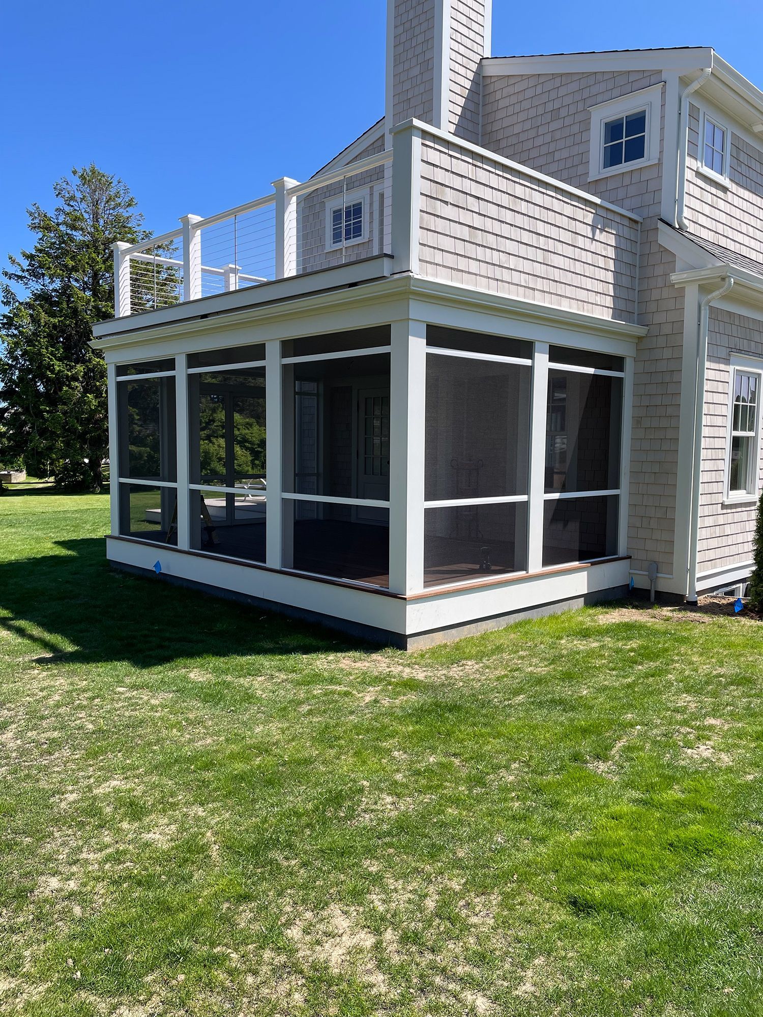 there is a screened in porch on the side of a house