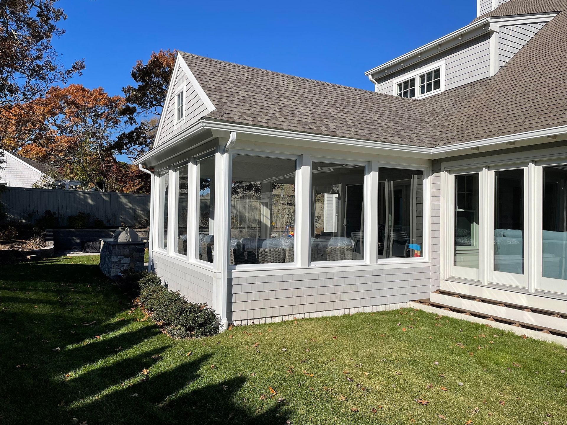 a house with a screened in porch and a lot of windows