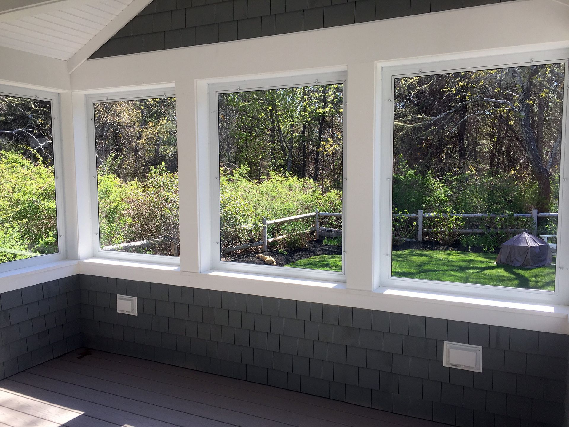 a room with a lot of windows and a view of trees