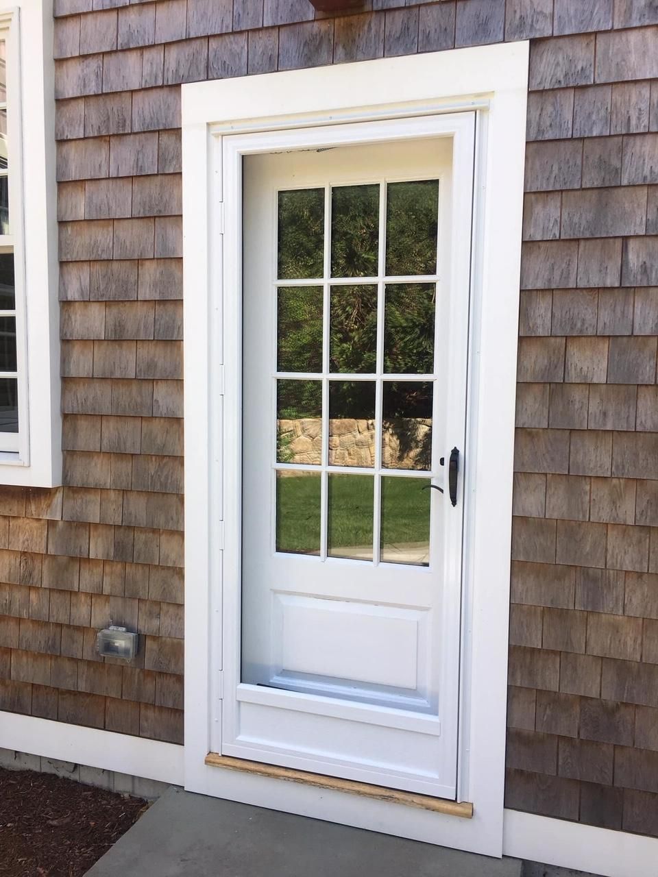 a white door is on the side of a house