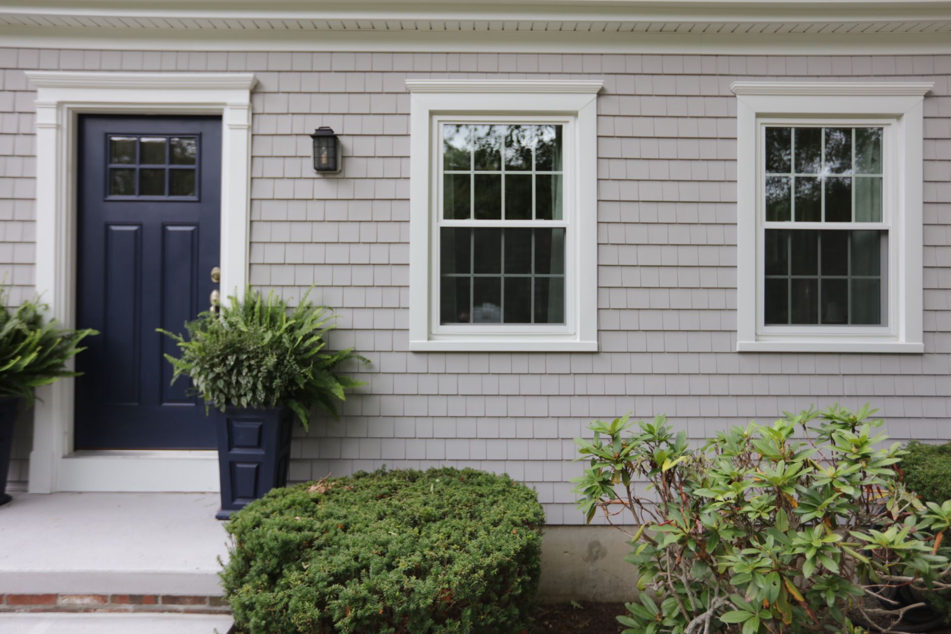 a house with a blue door and white windows