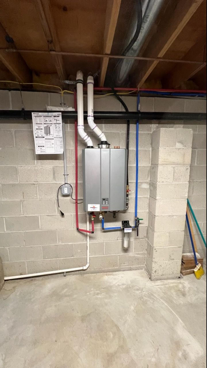 HVAC furnace and ductwork in a dim crawlspace with exposed pipes and wiring