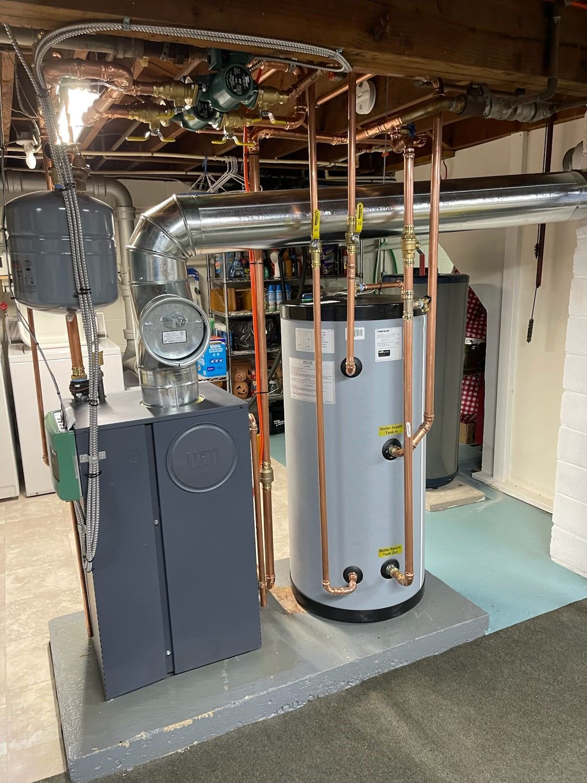 Basement furnace and water heater with exposed copper pipes and a front-mounted utility pump.