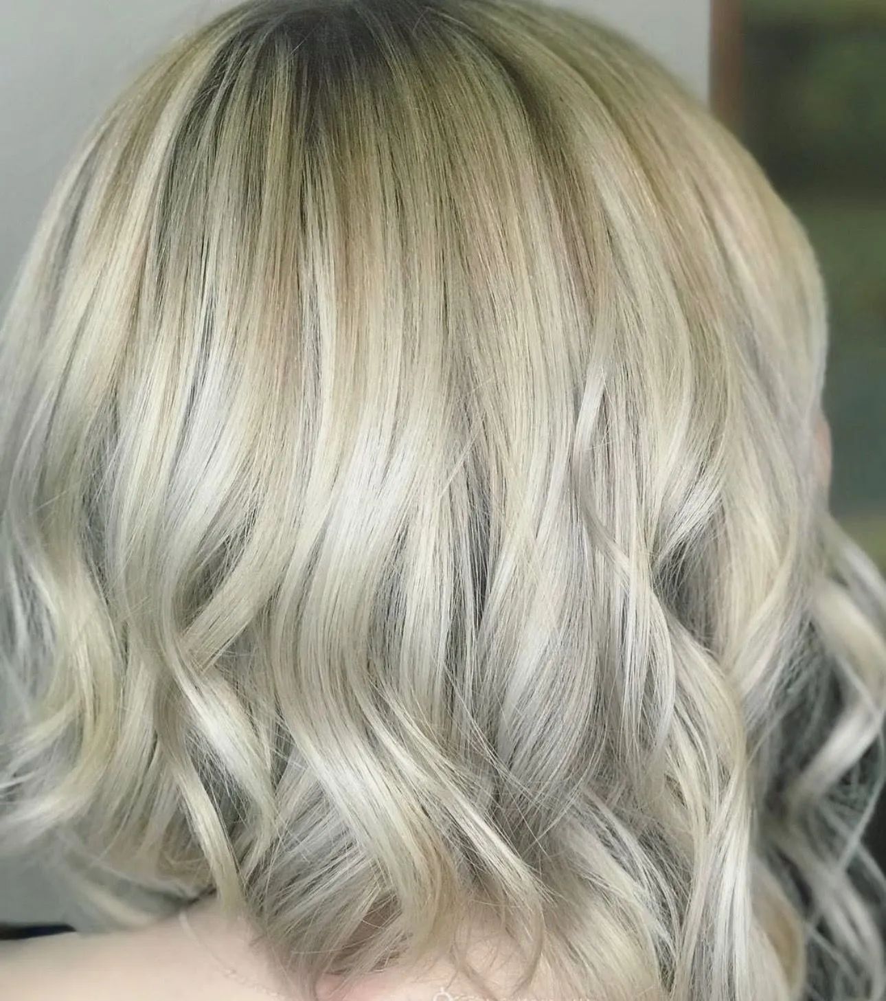 Shoulder-length hair with blonde highlights and soft, wavy texture.