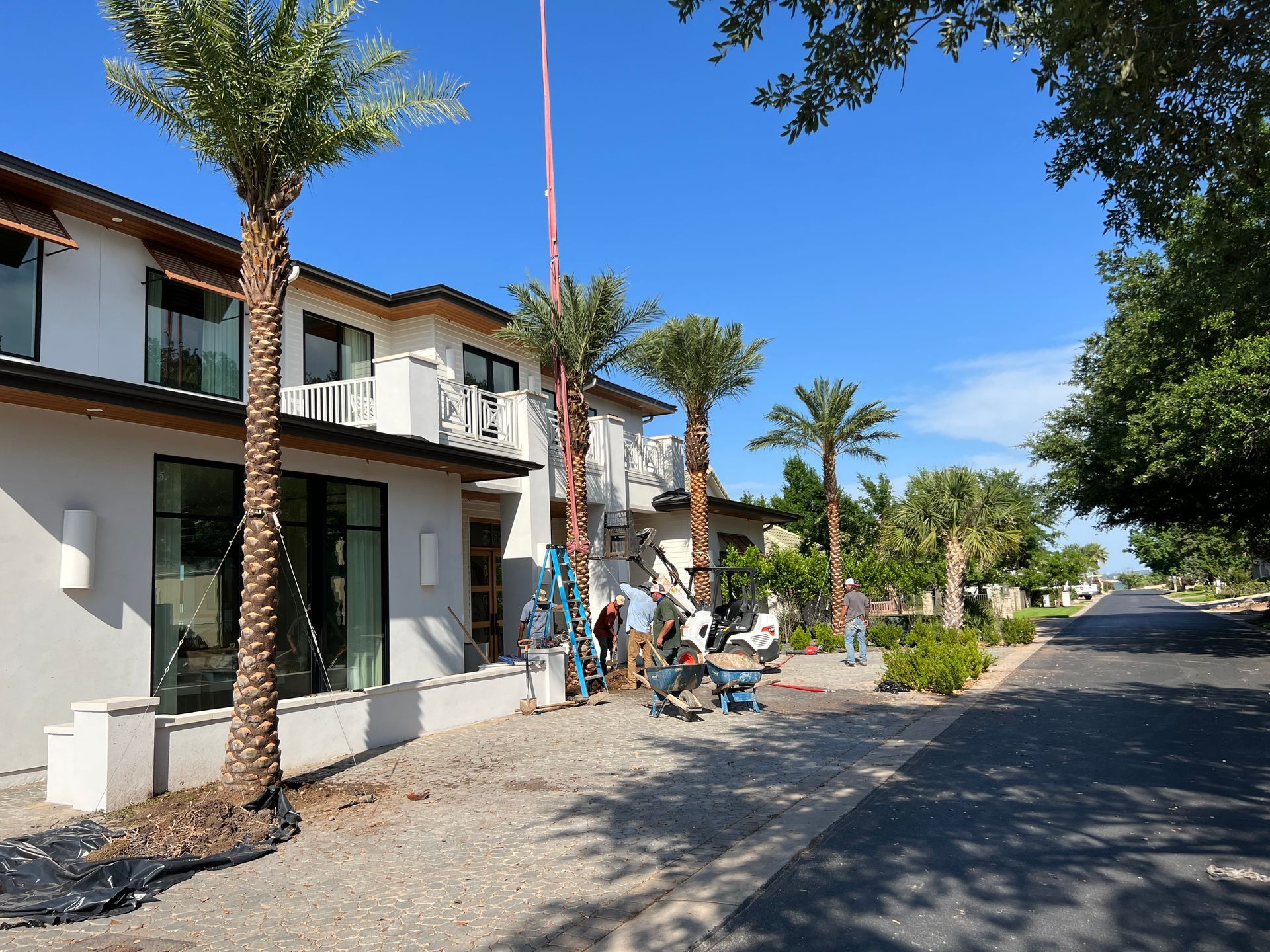 A large white house with palm trees in front of it
