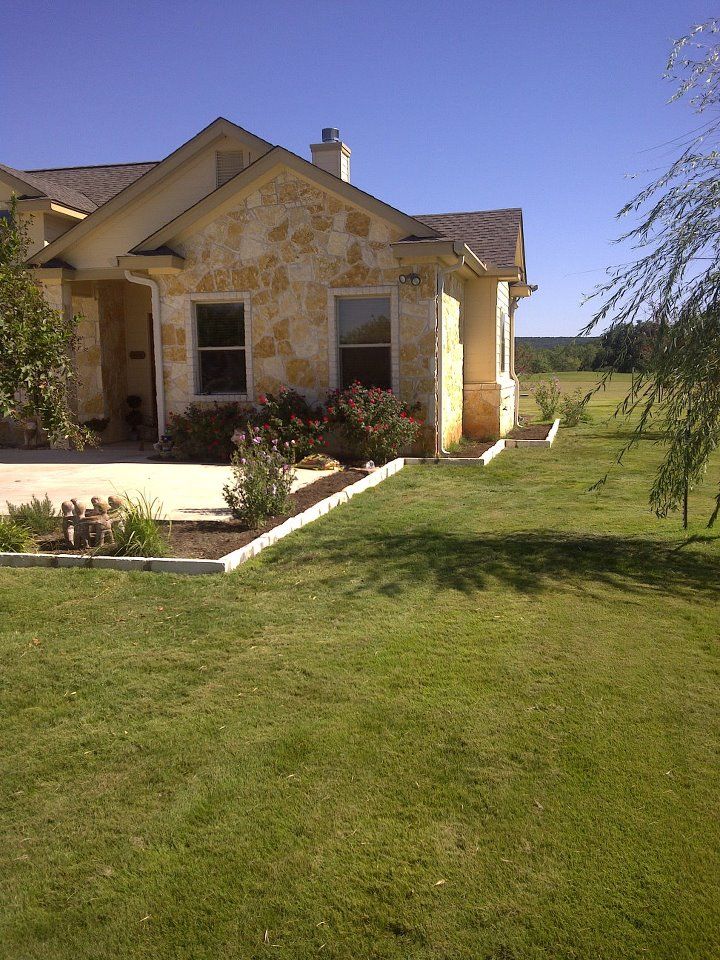 A house with a lush green lawn in front of it