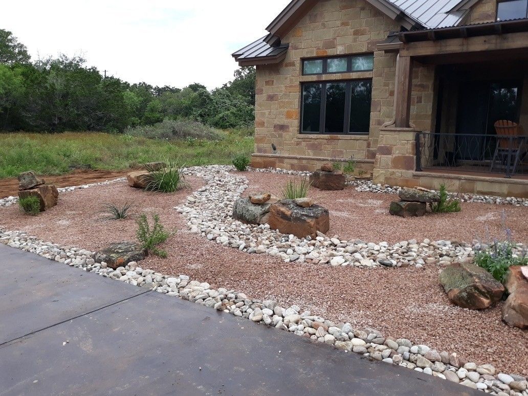 A house with a lot of rocks in front of it