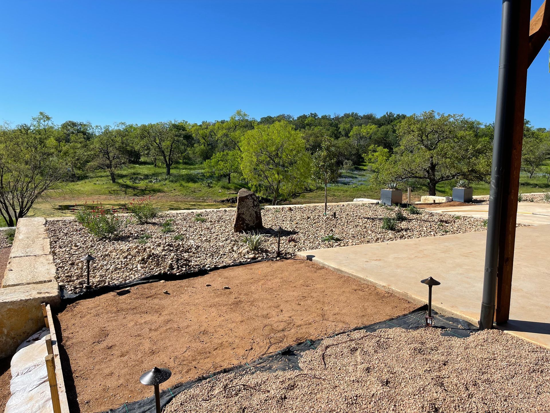 A view of a lush green forest from a porch.