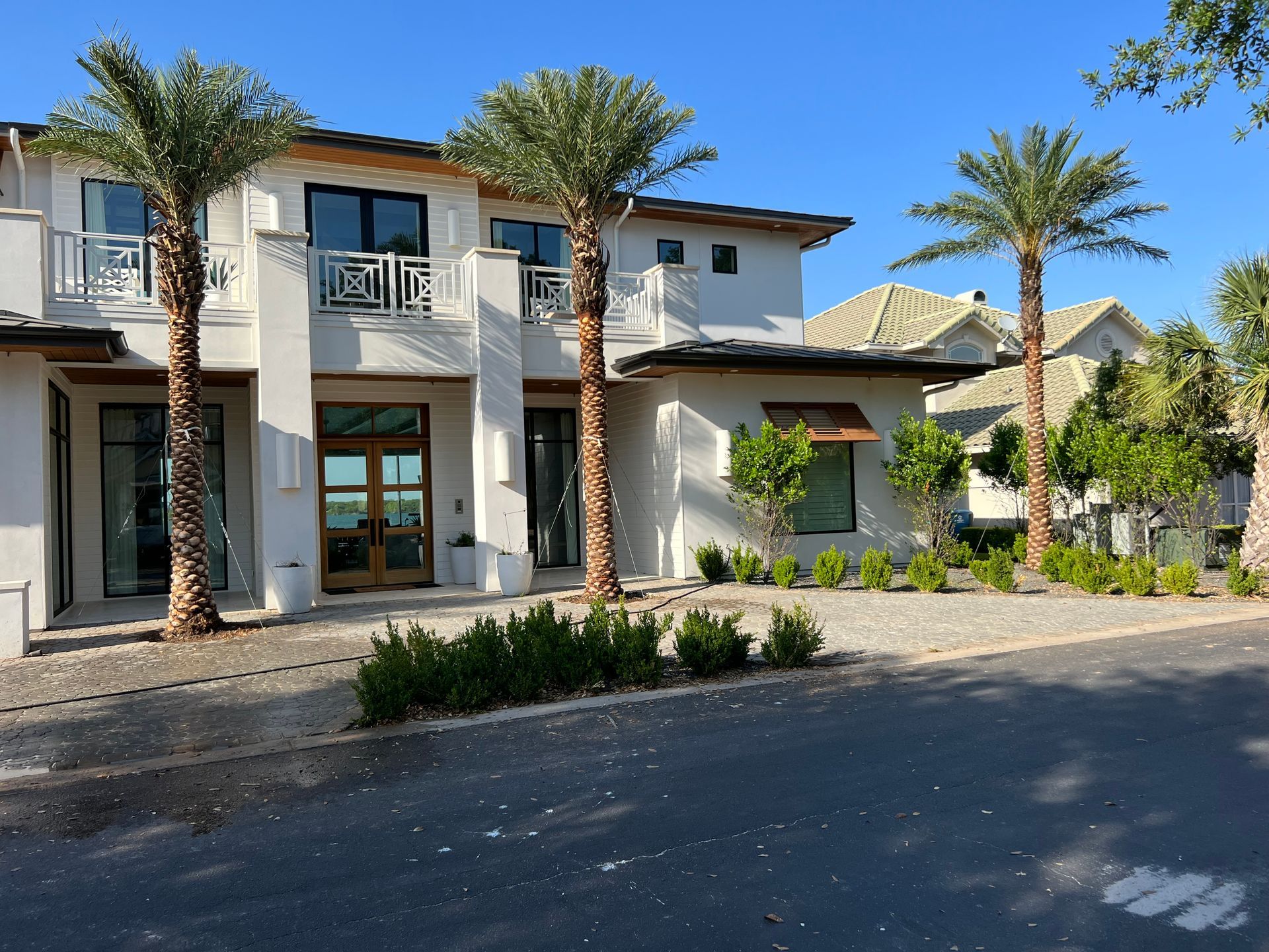 A large white house with palm trees in front of it