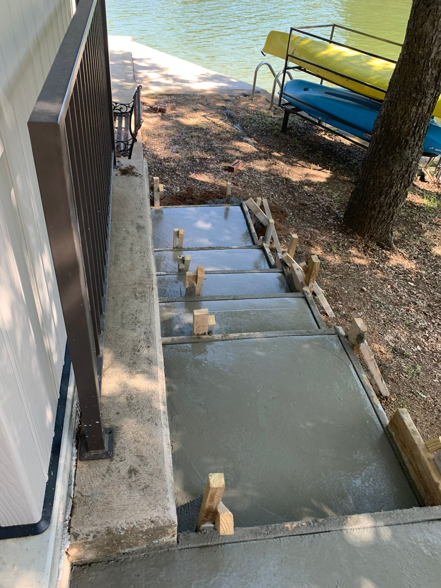 A set of concrete stairs leading up to a lake.