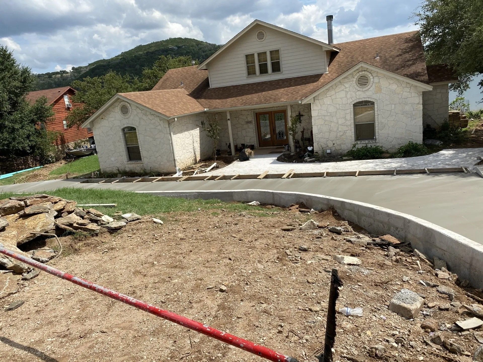 A large white house with a brown roof is being built