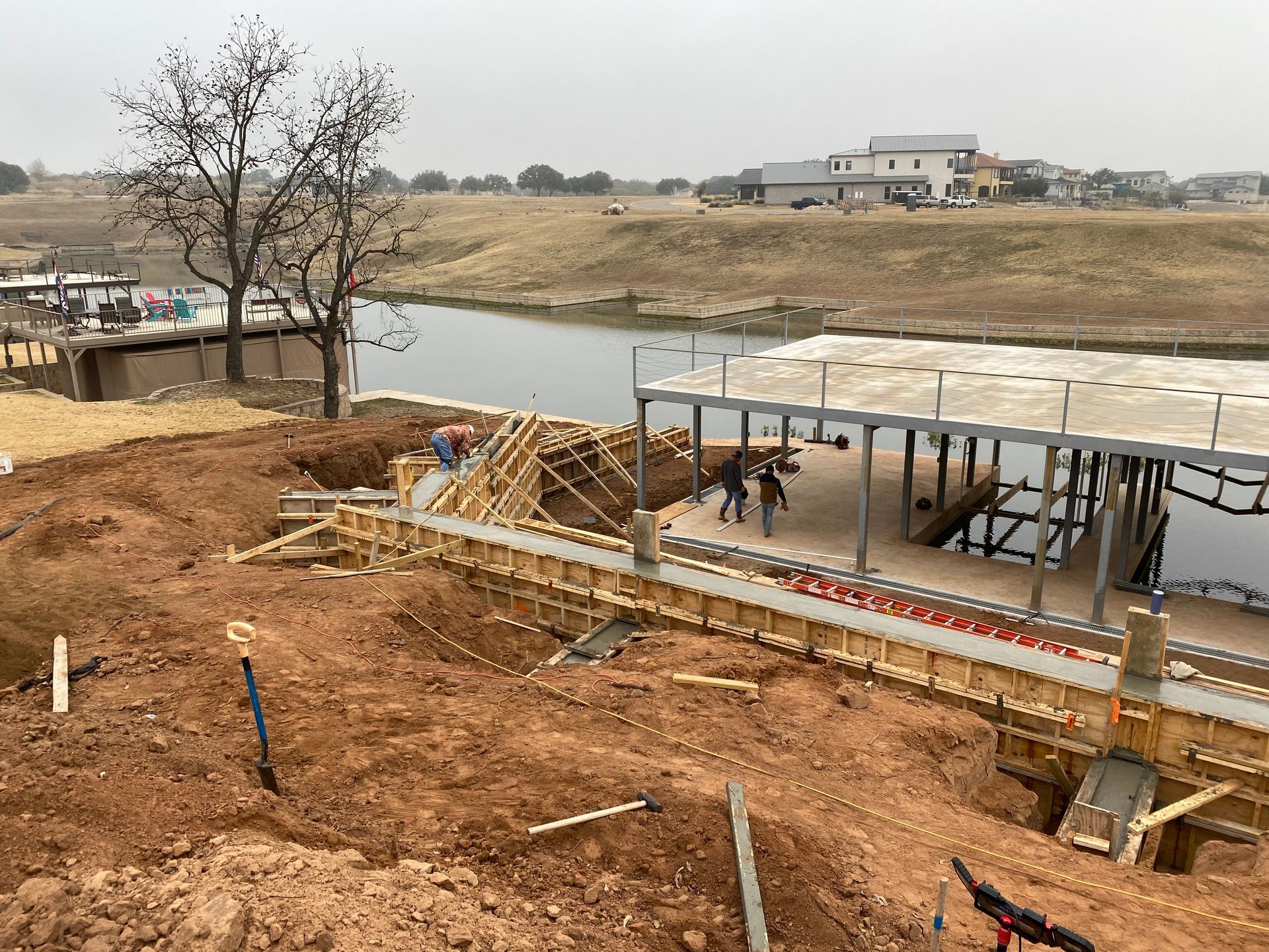 A building is being built next to a body of water.