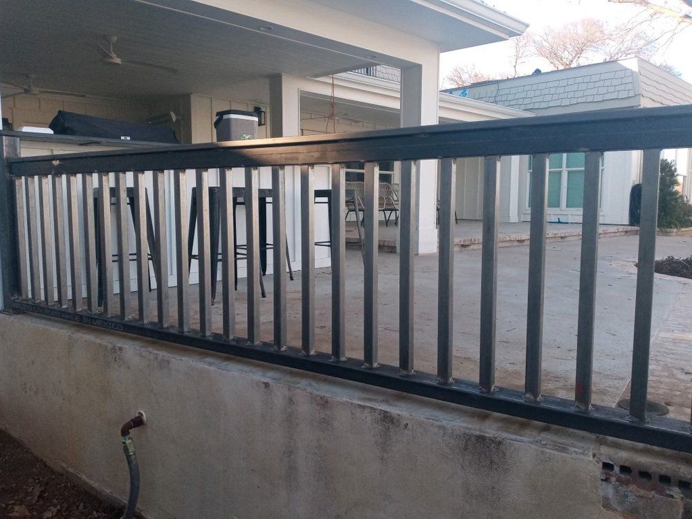 A black railing is sitting on the side of a house.