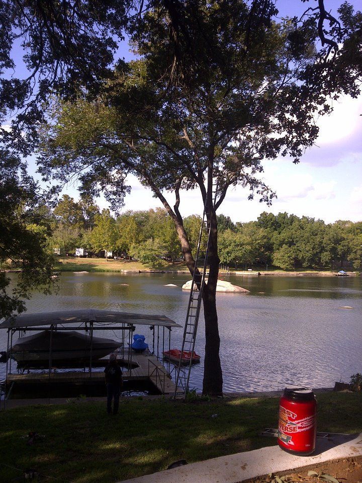 A can of coca cola sits in front of a lake