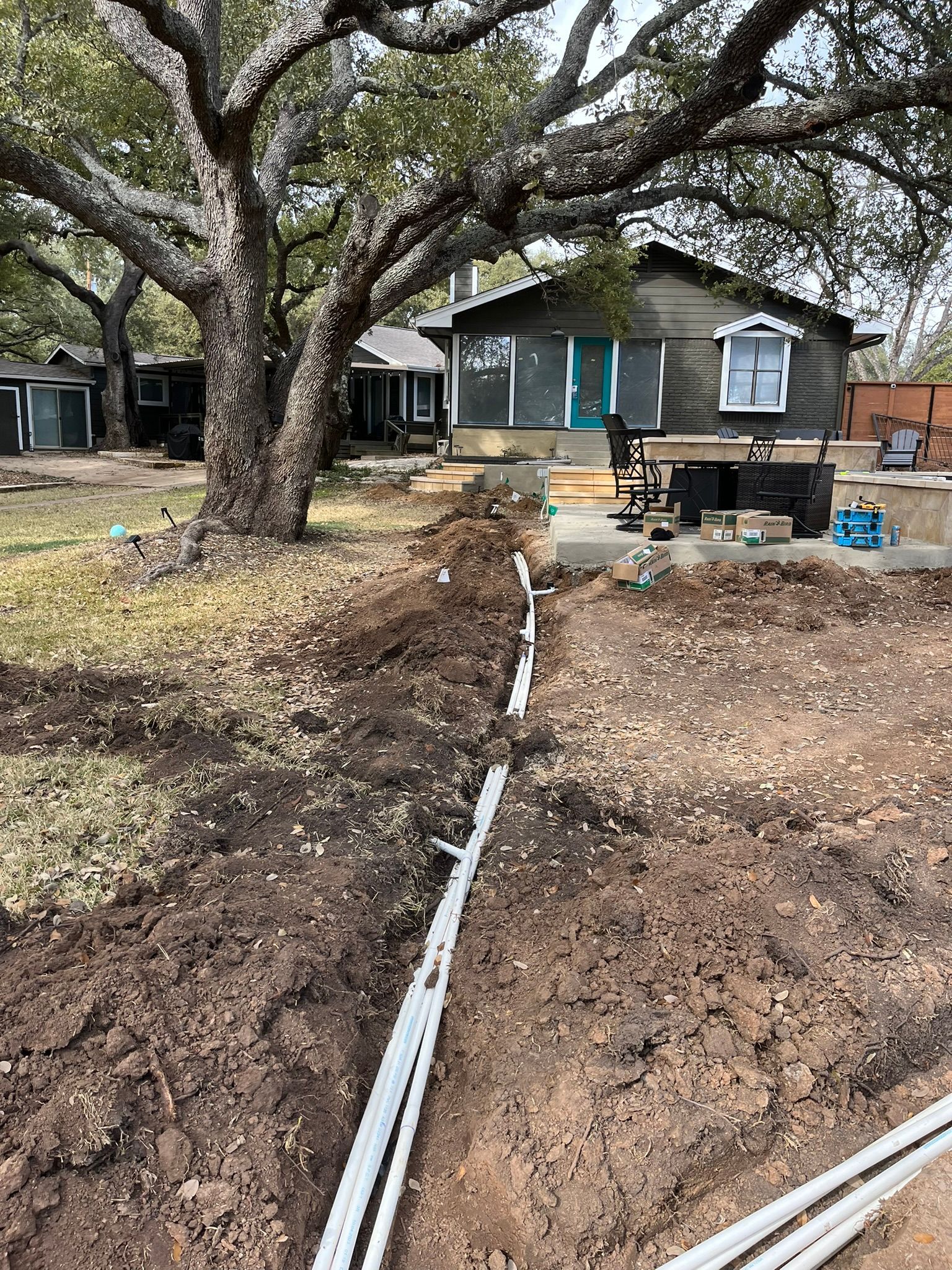 A house is being built in the middle of a dirt field.