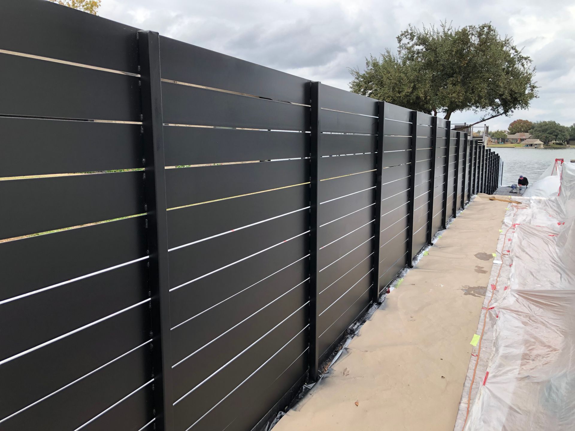 A black fence is being built.