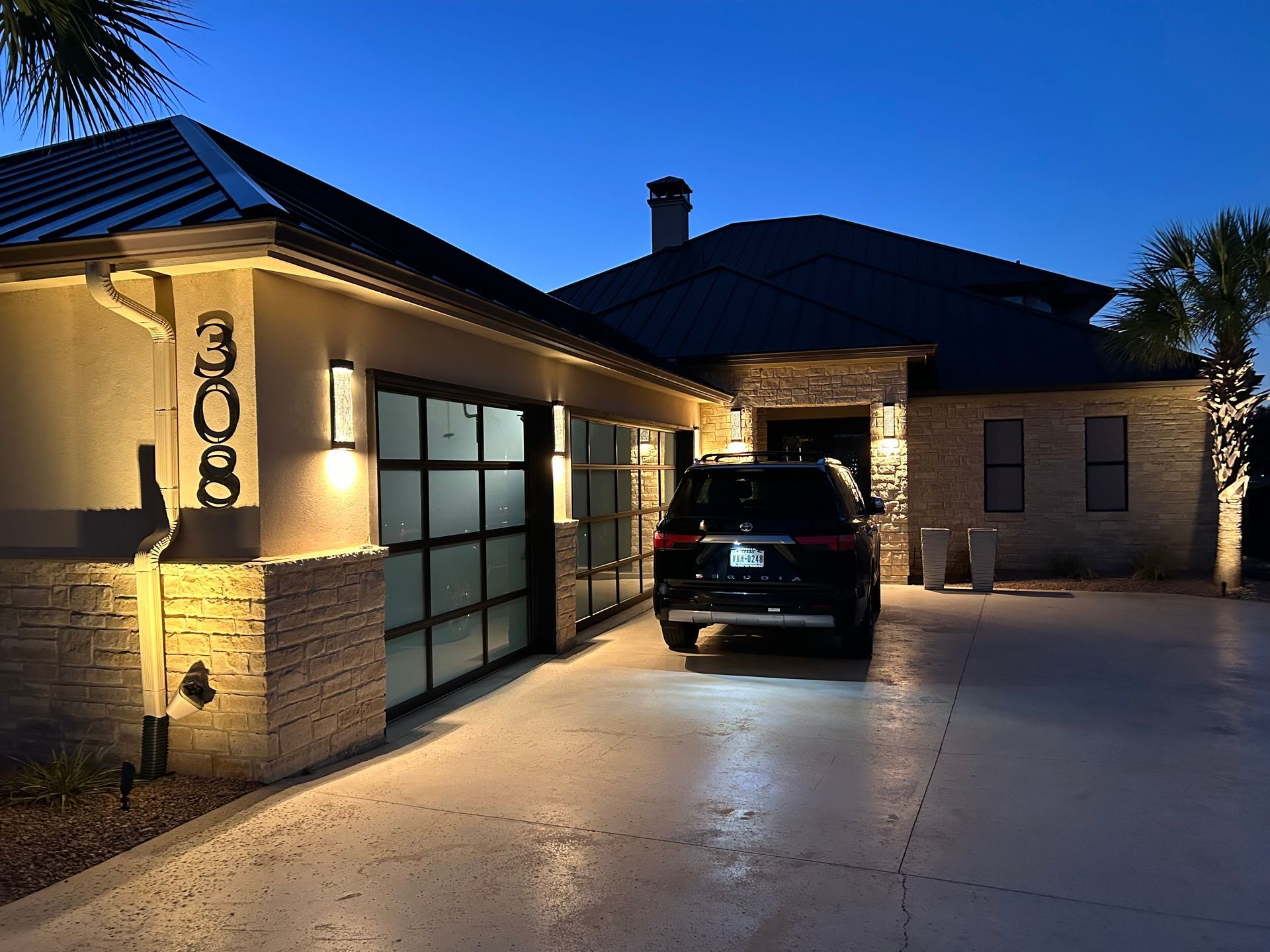 A car is parked in a driveway in front of a house
