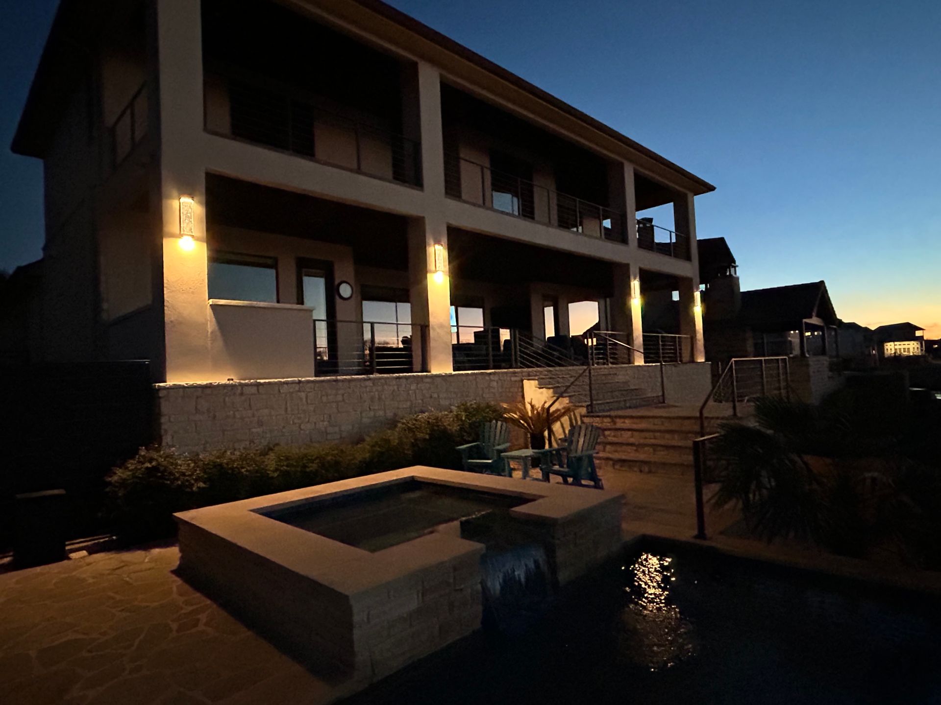 A large house with a swimming pool in front of it