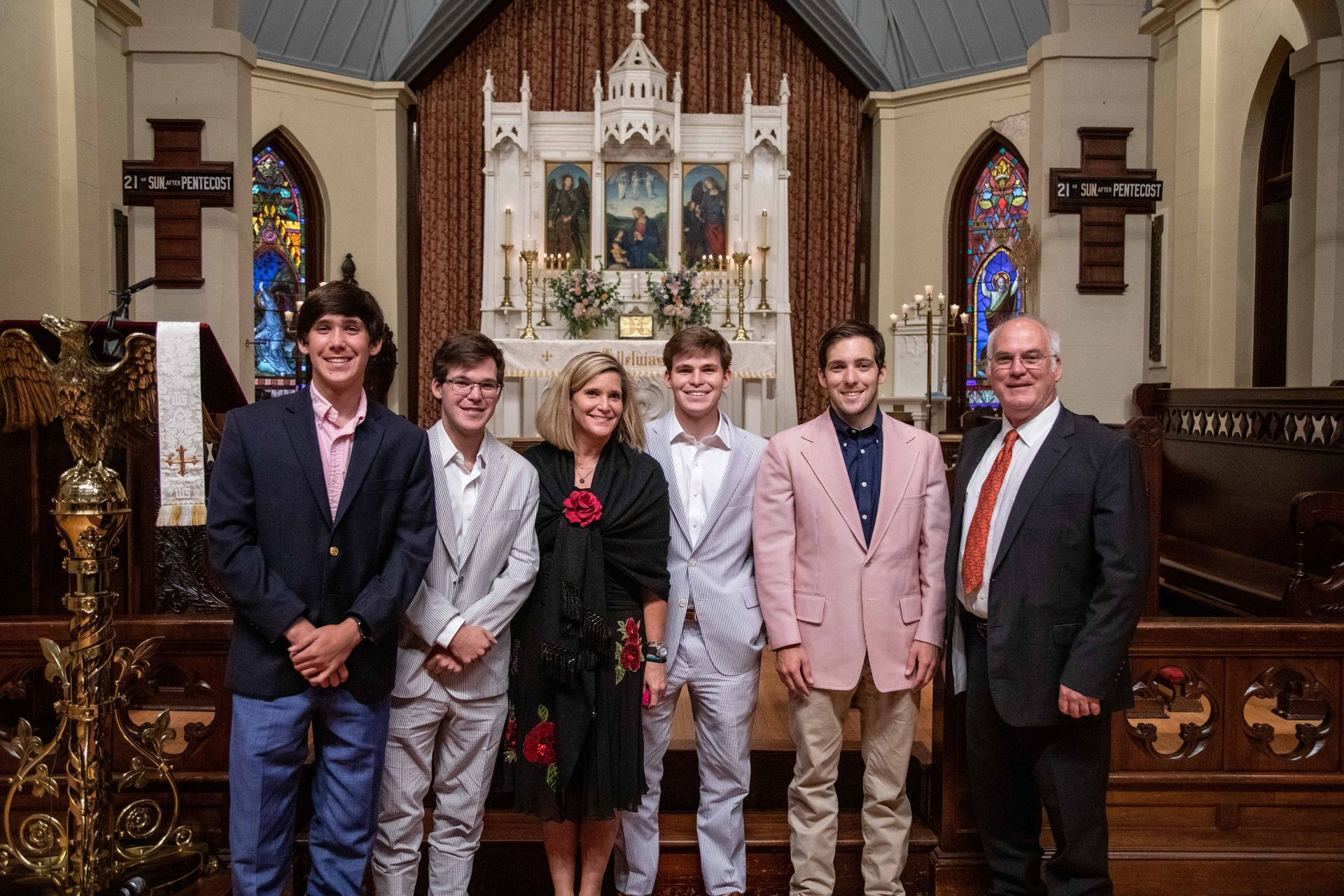 Dr. Jeff's family stands in front of an altar in a church