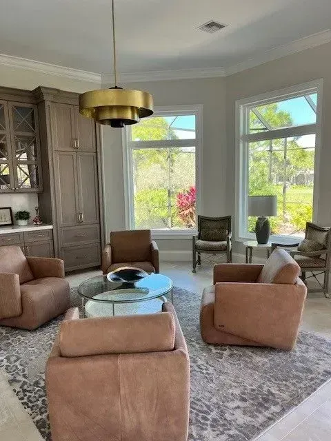 A living room with brown chairs and a coffee table.