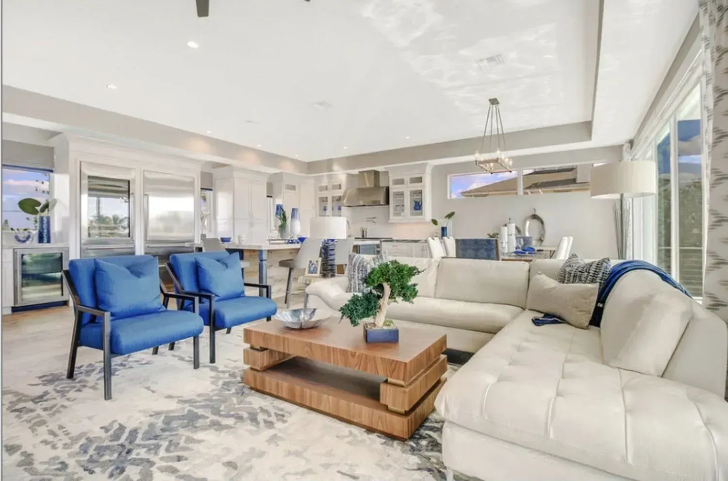 A living room with a couch, chairs, and a coffee table.