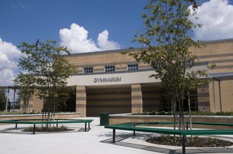 A large brick building with the word gymnasium on it