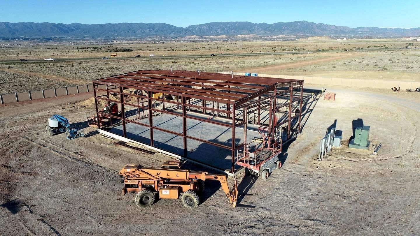 An aerial view of a building under construction in the desert