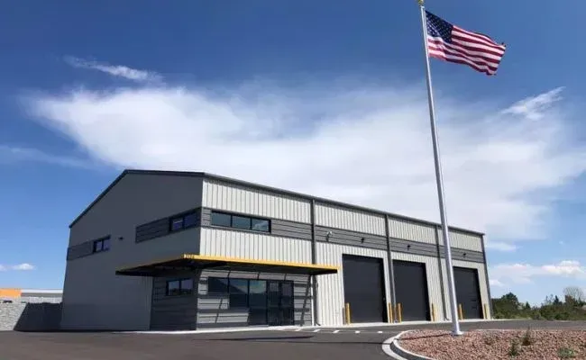 A large building with a flag flying in front of it.