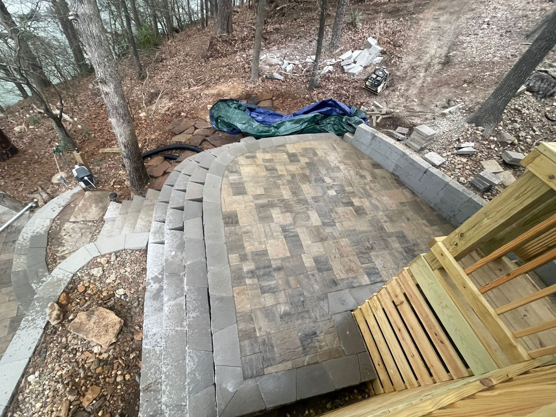 An aerial view of a deck and stairs in the woods.