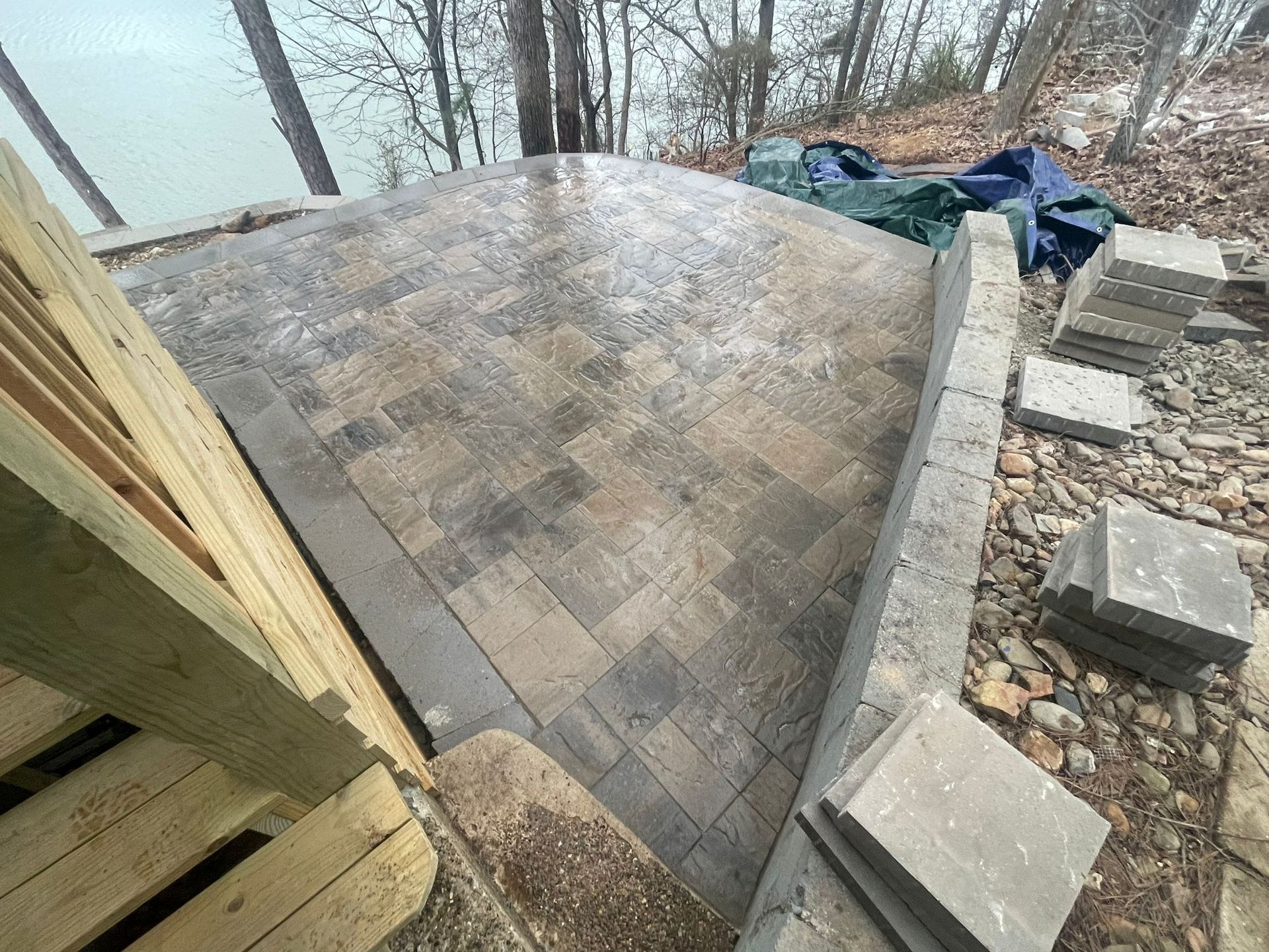 A patio is being built next to a body of water.