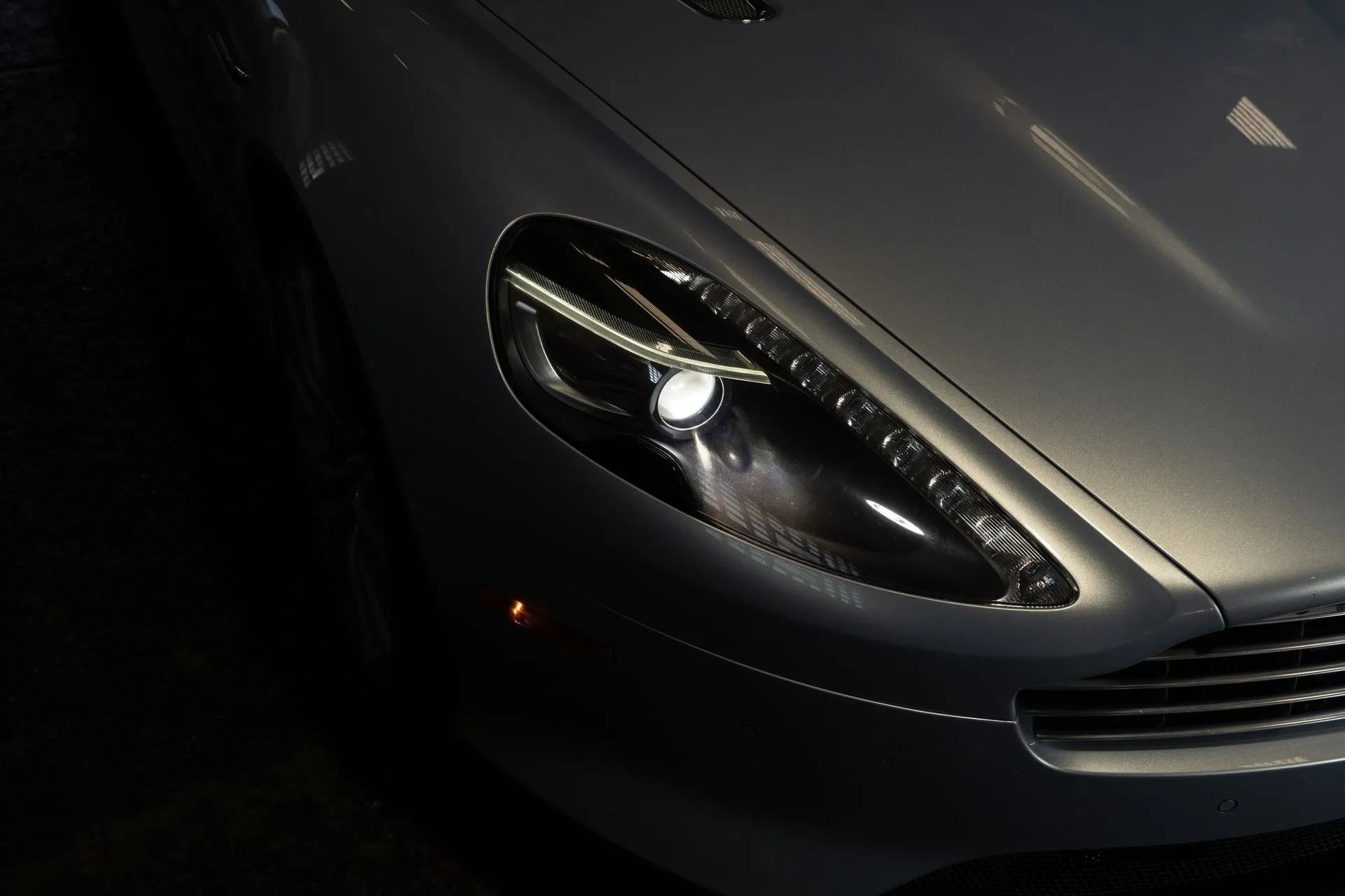 Silver Aston Martin headlight detail.