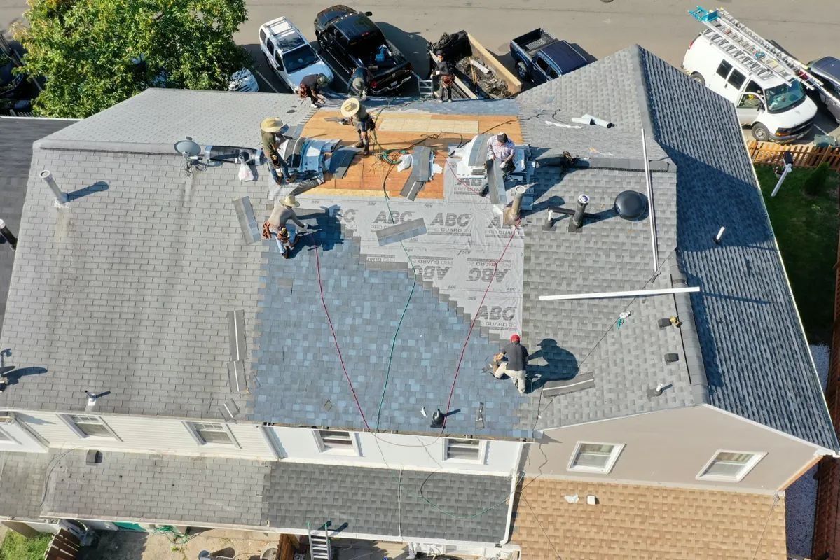 Roofers working on a house roof. 