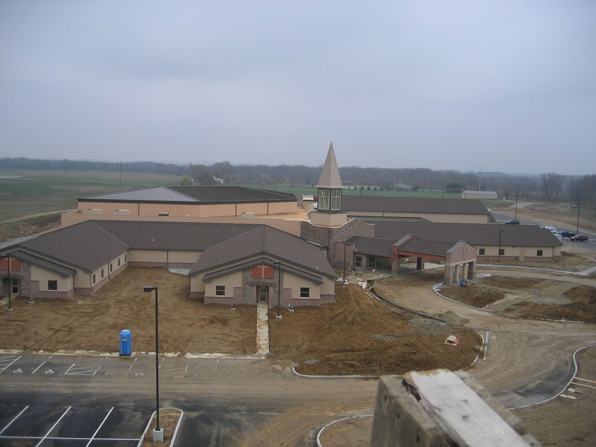 An aerial view of a building under construction on a cloudy day