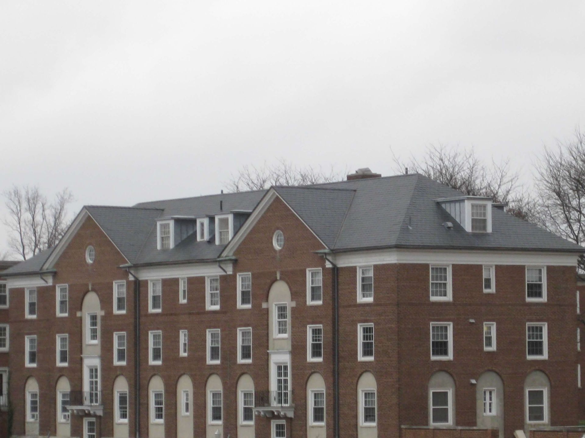 A large brick building with a gray roof
