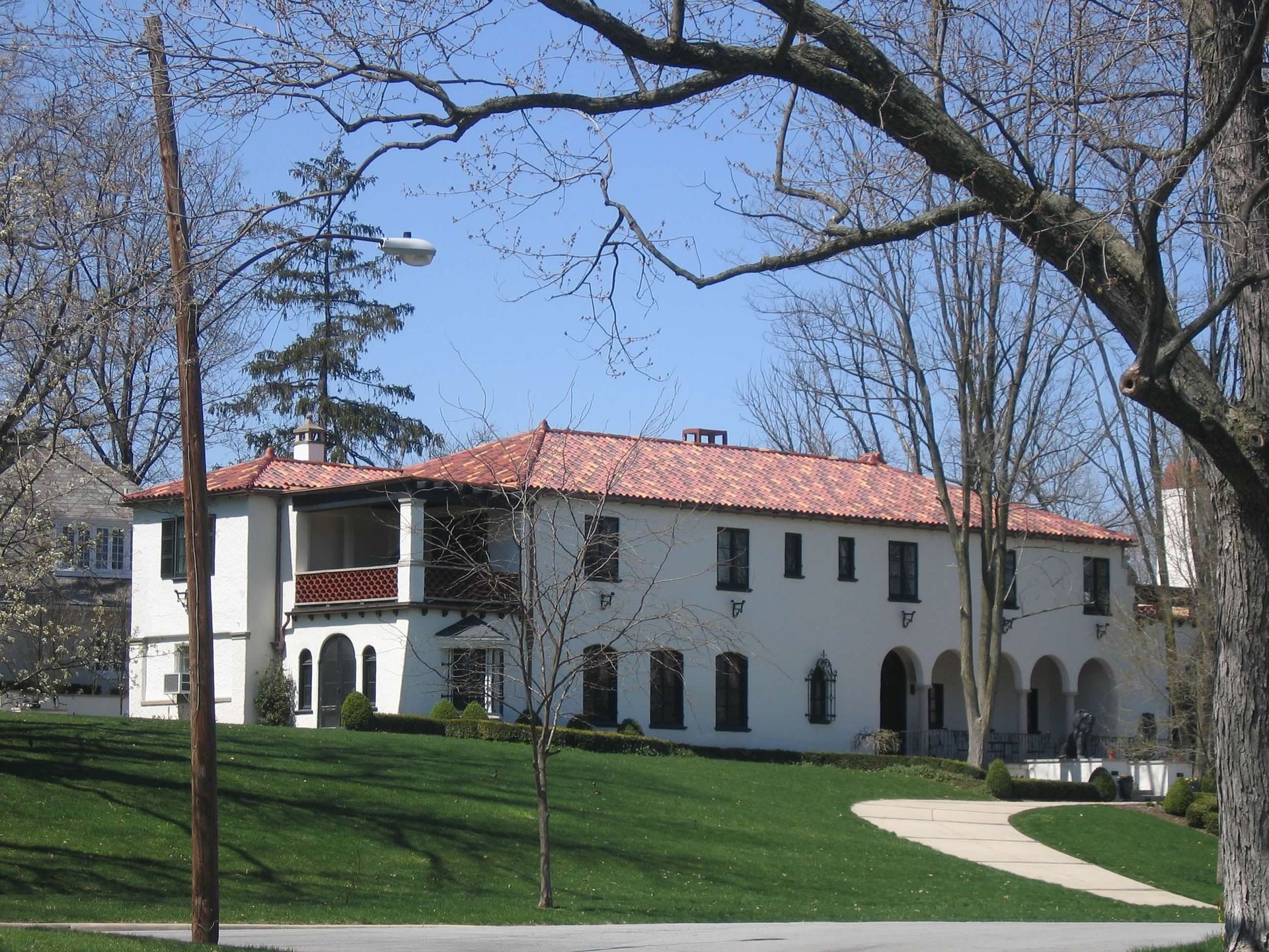 A large white building with a red tile roof