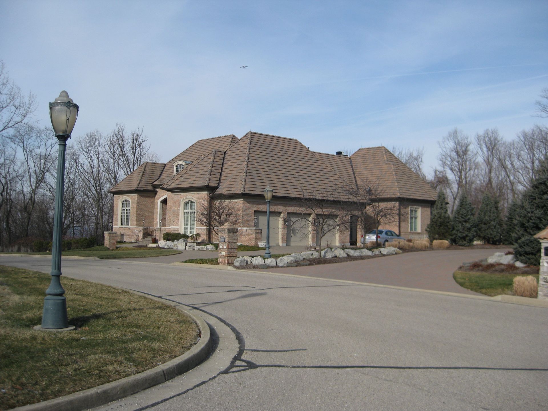 A large house sits on the corner of a street