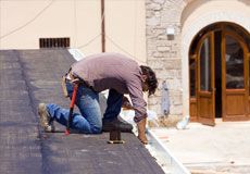 Contractor repairing gutter
