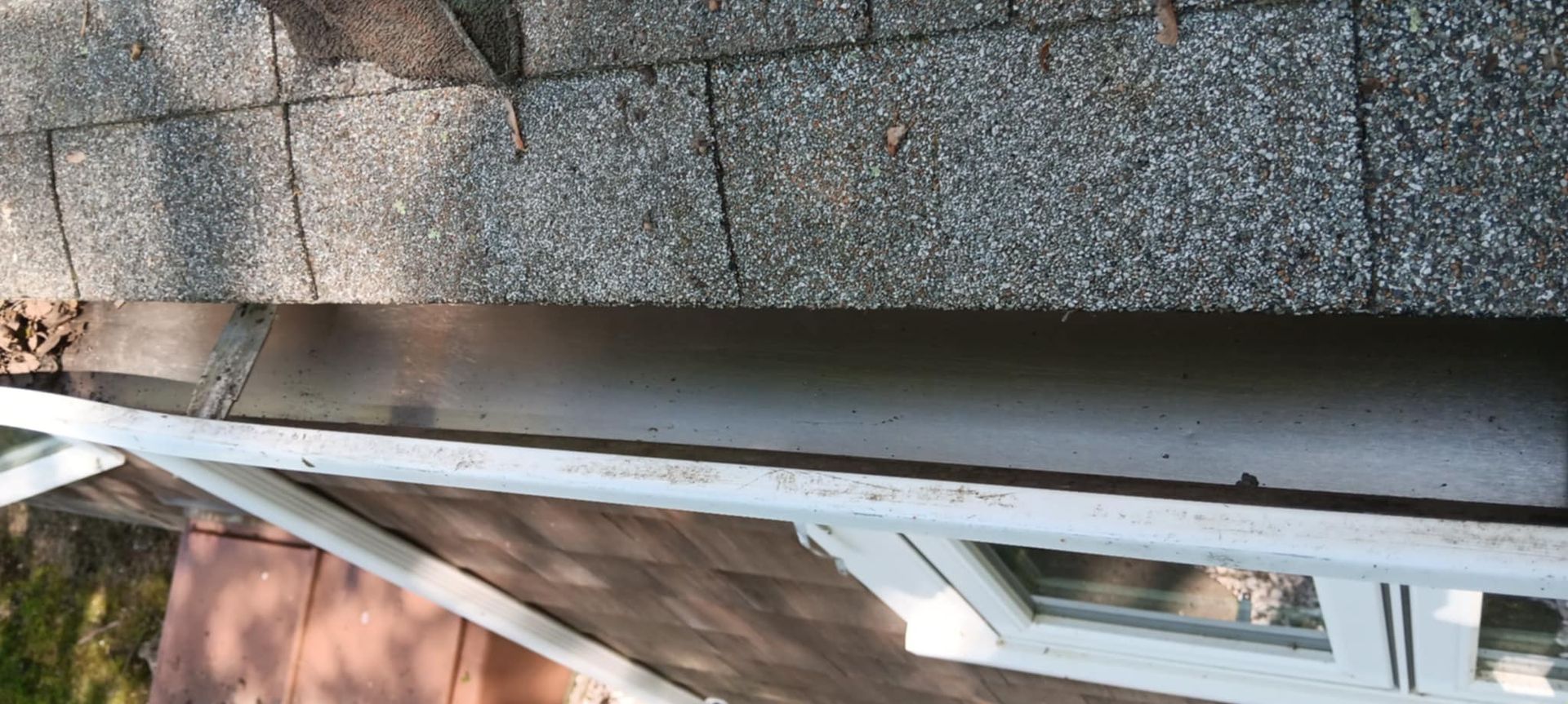 A close up of a roof with a window on it.