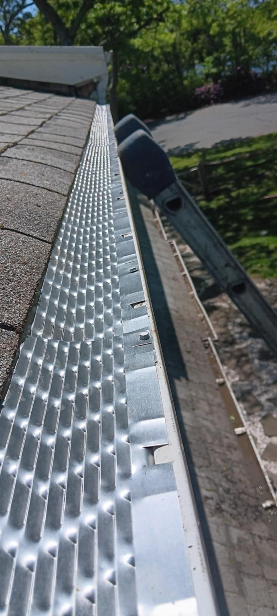 A close up of a gutter with a ladder attached to it.