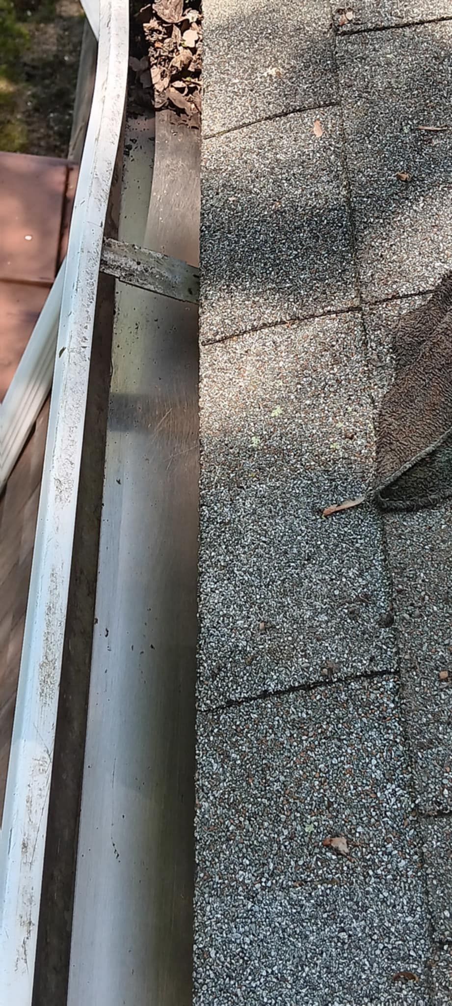 A close up of a gutter on a roof.