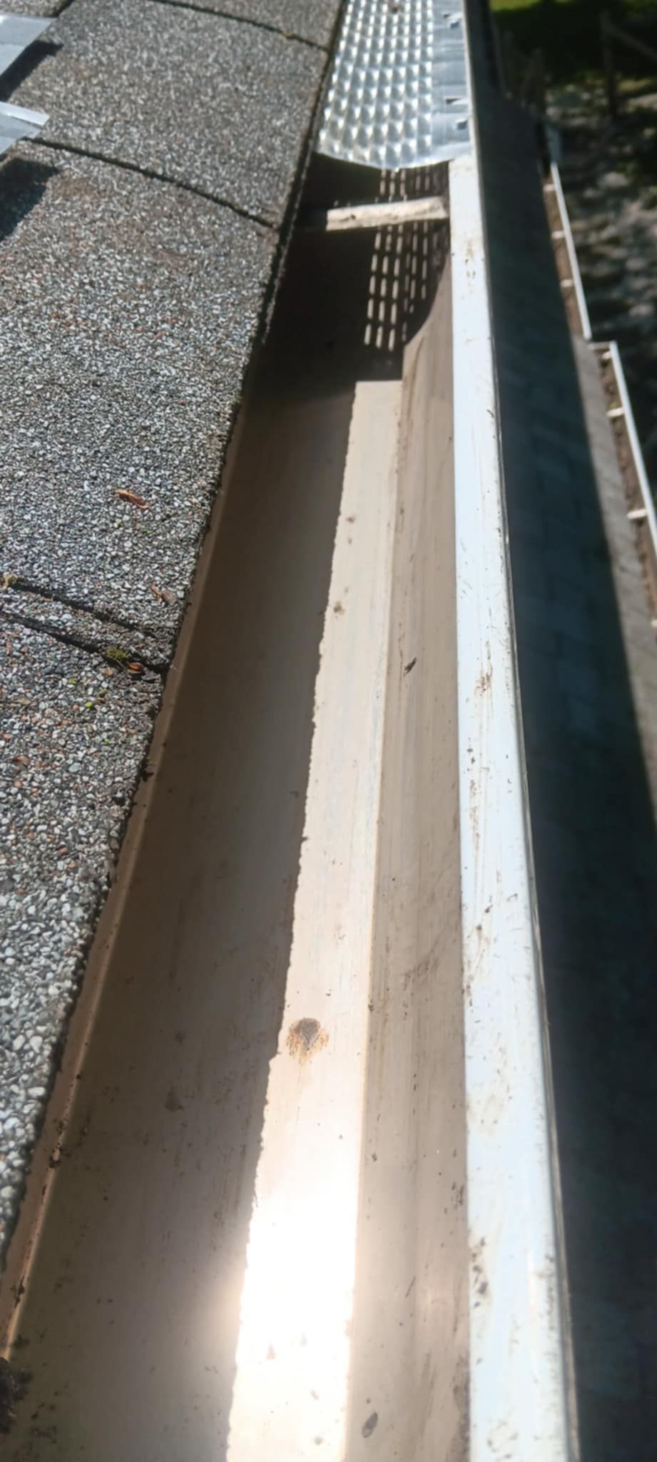 A close up of a gutter on a roof.