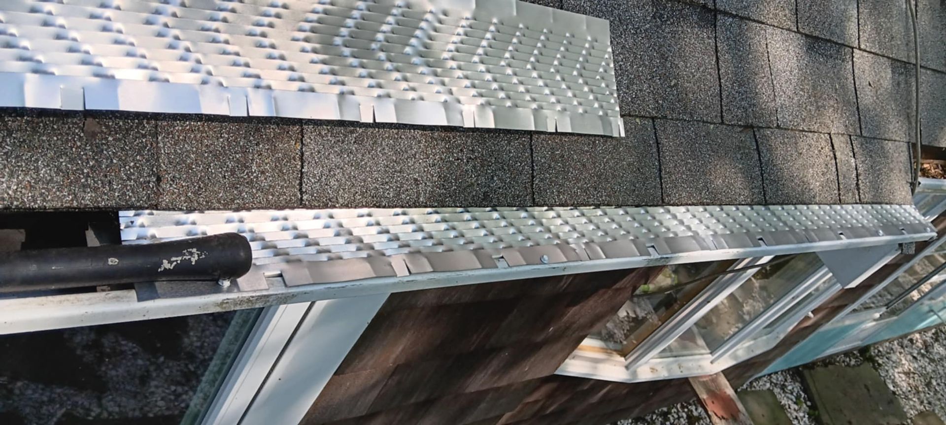 A roof with a metal gutter on it.