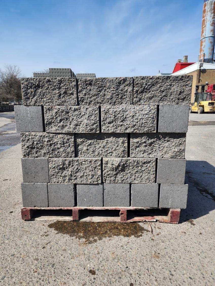 A pile of concrete blocks sitting on top of a wooden pallet.